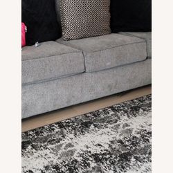 Gray Couch With Pillows And Patriots Throw Blanket