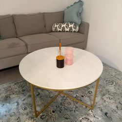 Grey couch, White Table, Black Bar Stools