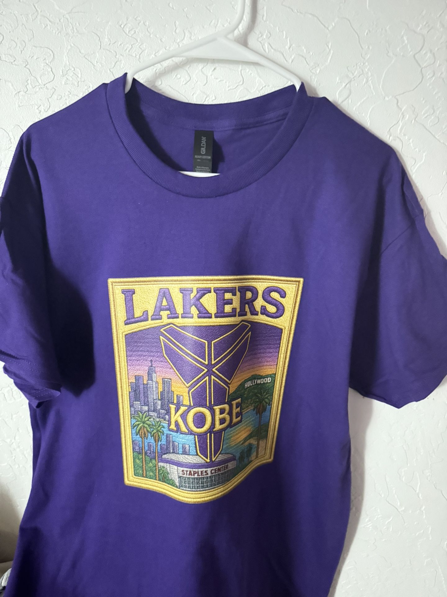 Show your Lakers pride and honor Kobe Bryant with this bold purple Mamba tribute tee – shirt perfect for true Los Angeles Lakers fans!