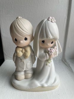 The 1979 Precious Moments figurine "The Lord Bless You and Keep You" (Model E-3114)