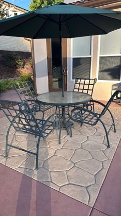 Patio chairs, table and umbrella