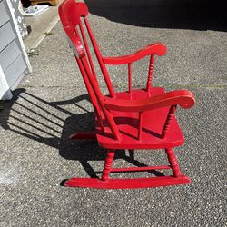 Children’s red spindled rocking chair