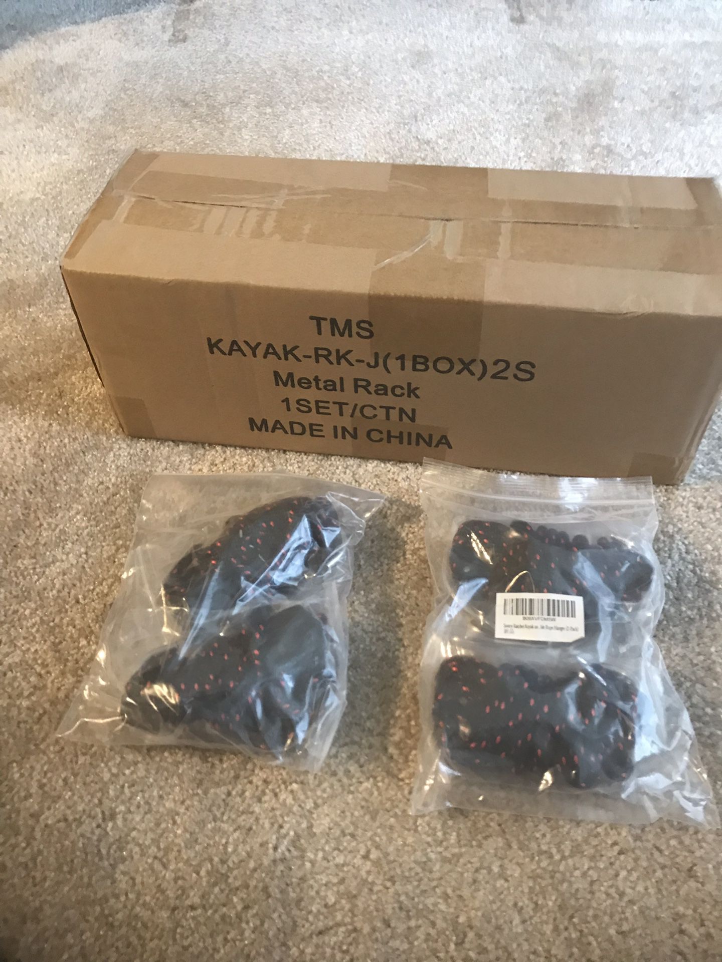 Kayak rack and rope/hooks that have not been unpackaged.