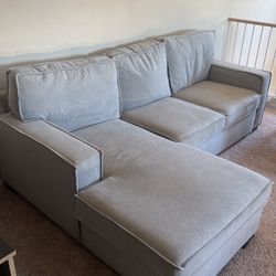 Grey Couch With Pullout And Blanket/pillow Storage