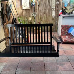 Black wooden porch swing