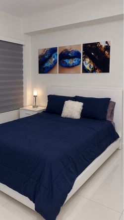 Queen bed with built-in lighting in the headboard