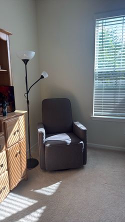 Gray Upholstered Swivel Accent Chair and lamp