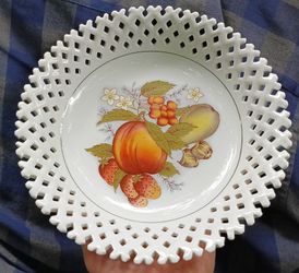 A vintage porcelain lattice-edge bowl with a fruit and floral motif.