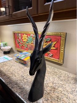 Mid-century modern stylized antelope head sculpture, likely made from brass or bronze with polished silver-toned horns
