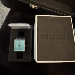 NOXIN watch, featuring a rectangular turquoise face