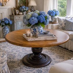 The Hekman Round Pedestal Dining Table in a walnut finish