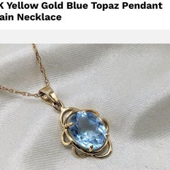 14K gold pendant with  blue topaz stone 19 inches long and 2.2 grams of 14K gold