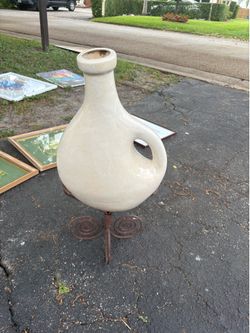 Large vase on iron stand. Beige