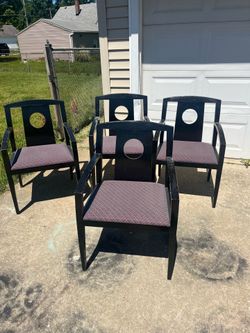 4 black chairs with padded seats