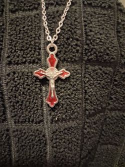 Red silver cross necklace with Jesus on it