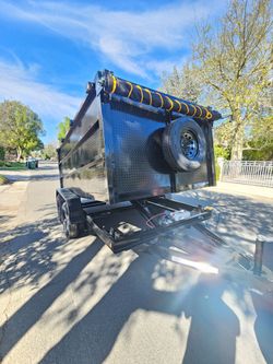 NEW DUMP TRAILER 12X8X4 12000 LBS
ROLLING TARP--SPARE TIRE,ELECTRIC BRAKES,HYDRAULIC SYSTEM,REMOTE CONTROL,IDEAL FOR HAULING, DEMOLITION, TRASH ETC,