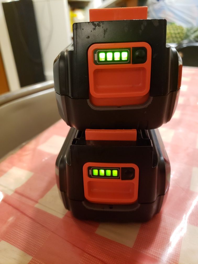 Black and decker charger with two 40v batteries.