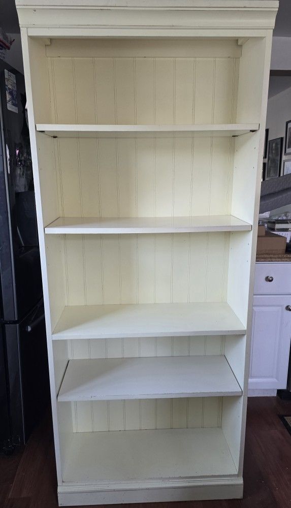 Cream color solid bookshelf adjustable.
