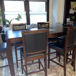 Counter height dining table and matching  black leather chairs