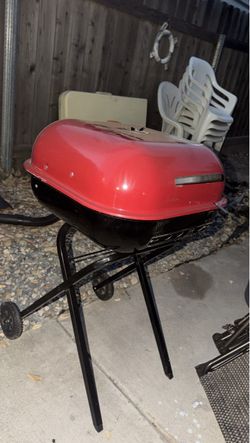Red and Black Charcoal Grill on Stand
