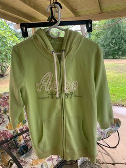 This Aeropostale lime green zip-up hoodie features white drawstrings and a prominent