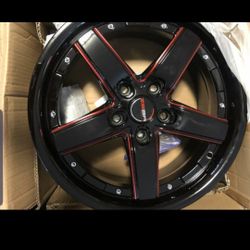 Un par de rines marca zaba de 5 birlos color negro con rojo