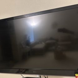 LG TV with modern TV Stand + Apple TV 