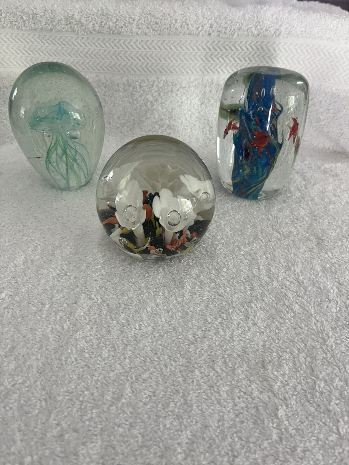 Three Glass Paperweights With Aquatic And Floral Themes