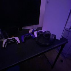 ps5 with 3 controllers and a headset