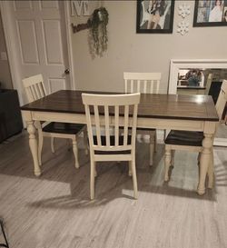 Selling our farmhouse-style dining table. It is in great condition, sturdy, and features a lovely dark wood top with cream/off-white base and chairs. 