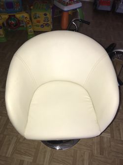 2 white leather chairs