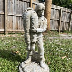 Concrete Solider Carrying Fellow Solider Statue
