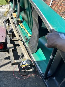 Boat With Trailer And Trolling Motor Also Has Paddles