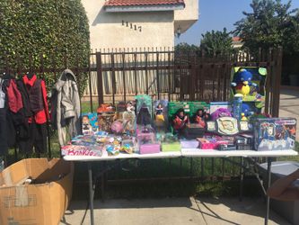 Yard sale of toys, clothes, shoes, purses