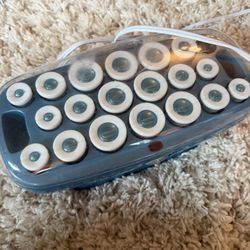 Stylish hair roller set in blue and white. Perfect for creating stunning curls. Missing one.