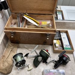 fishing reels and tackle box full of lures hooks and other stuff