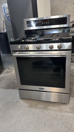 Maytag stainless steel natural gas stove; includes a receipt for a 90-day warranty.