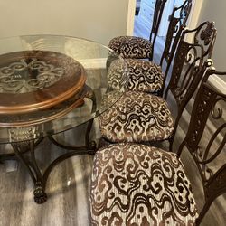 Glass top dining table with 4 chairs .  