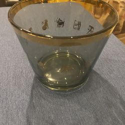 Vintage glass ice bucket with gold trim, and various zodiac sign illustration