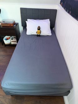 Twin bed with headboard and mattress