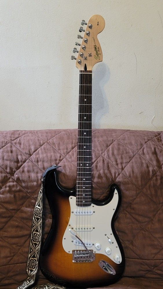 SQUIER STRATOCASTER BY FENDER AFFINITY SERIES ELECTRIC GUITAR MADE IN INDONESIA IN SUNBURST COLOR.