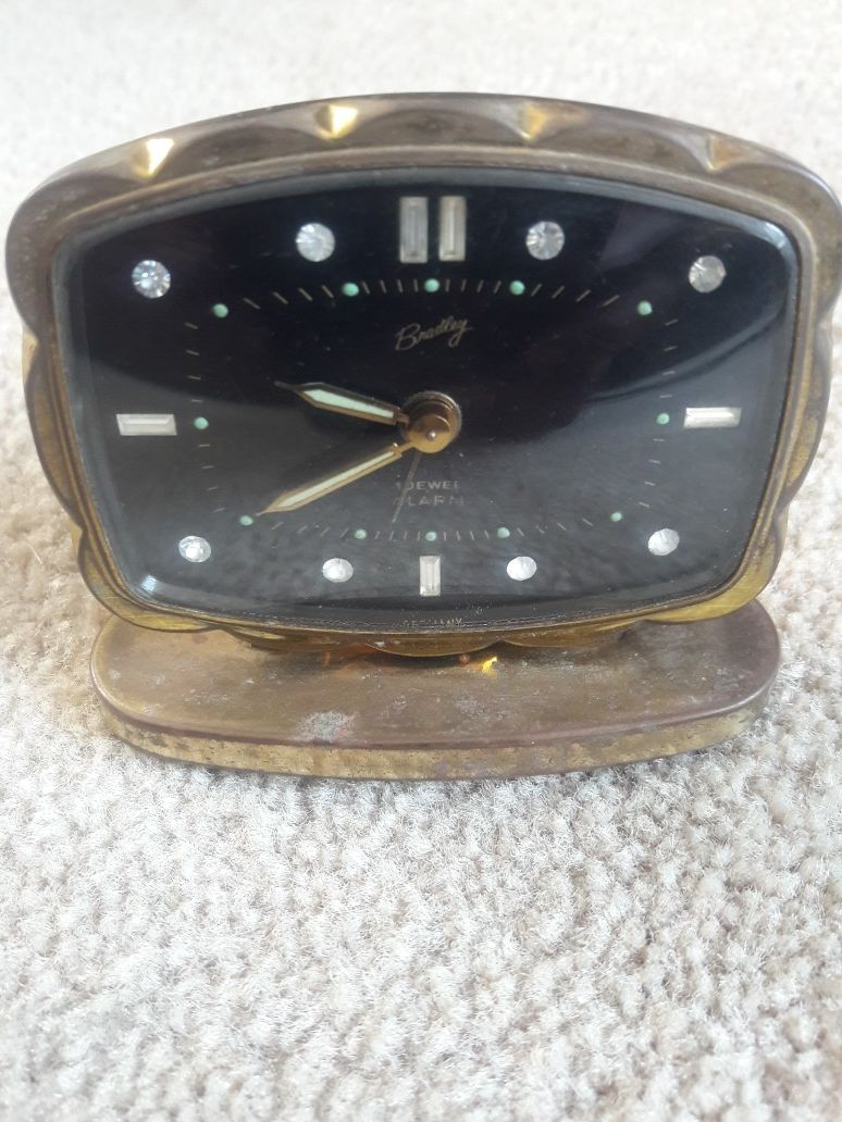 Antique wind-up glow alarm clock