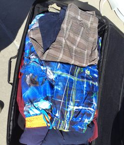 Large suitcase full of clothes for boys includes t shirts 2 basket ball shorts, walking shorts nice dress shirts and uniform polo shirts