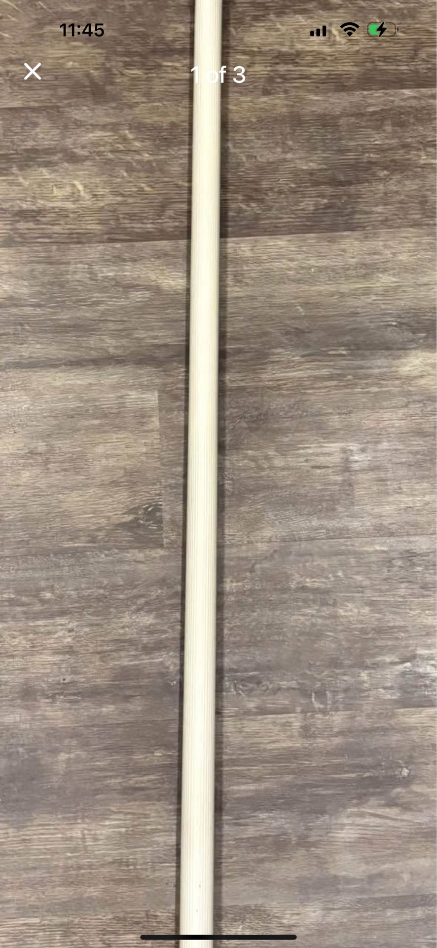 Shower rod pole extends beige bathroom with hooks