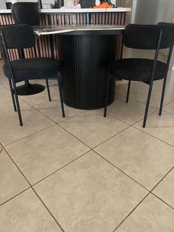 Round Dining Table with 2 Boucle Chairs.