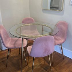 Glass Table With Four Pink Chairs