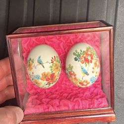 hand-painted Japanese eggs in a display case with beautiful flowers and birds