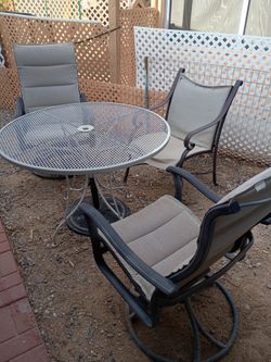 Metal mesh patio set with red umbrella