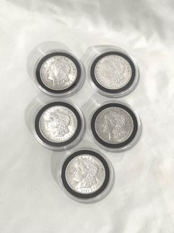 About uncirculated sealed in capsules (5)  1921 Morgan silver dollars.
