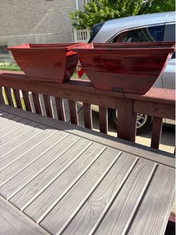 Two rectangular red plastic planter boxes